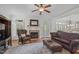 Bright living room features a fireplace, ceiling fan, and a comfortable seating arrangement at 2832 Cameron Pond Dr, Cary, NC 27519