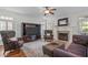 Bright living room with hardwood floors, fireplace, and elegant furnishings at 2832 Cameron Pond Dr, Cary, NC 27519