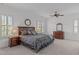 Spacious main bedroom with a ceiling fan, plantation shutters, and a decorative mirror at 2832 Cameron Pond Dr, Cary, NC 27519