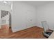Bright empty room with hardwood floors, double doors, and potential for customization at 2832 Cameron Pond Dr, Cary, NC 27519