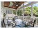 Inviting screened porch with comfortable seating, a ceiling fan, and backyard views at 2832 Cameron Pond Dr, Cary, NC 27519