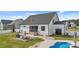 Spacious backyard boasts a refreshing in-ground pool, patio with seating, and plenty of green space for outdoor activities at 30 Devilwood Dr, Four Oaks, NC 27524