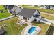 This large backyard offers a pool, patio, and ample green space, enhanced by a classic white fence and mature trees at 30 Devilwood Dr, Four Oaks, NC 27524
