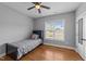 This bedroom features a bed, ceiling fan, and a window at 30 Devilwood Dr, Four Oaks, NC 27524