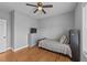 Bedroom with a bed, dresser, ceiling fan, and hardwood floors at 30 Devilwood Dr, Four Oaks, NC 27524