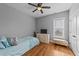 Cozy bedroom with hardwood floors, light-blue bedding, ceiling fan and neutral walls at 30 Devilwood Dr, Four Oaks, NC 27524