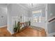 Welcoming foyer featuring a wooden console table, stylish mirror, plants, and a decorative rug at 30 Devilwood Dr, Four Oaks, NC 27524