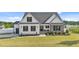 Charming two-story home with well-manicured lawn, stone accents, black shutters, and covered front porch at 30 Devilwood Dr, Four Oaks, NC 27524