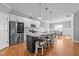 Bright kitchen with a large center island, seating, stainless steel appliances, granite counters, and an adjoining dining area at 30 Devilwood Dr, Four Oaks, NC 27524