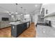 Well-equipped kitchen with island, stainless steel appliances, and open layout to the living area at 30 Devilwood Dr, Four Oaks, NC 27524