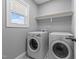 Laundry room with a washing machine, dryer, and a window at 30 Devilwood Dr, Four Oaks, NC 27524