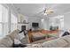 Spacious living room with plush seating, fireplace, and large windows for ample natural light at 30 Devilwood Dr, Four Oaks, NC 27524