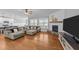 Comfortable living room with fireplace, sectional sofa, and open layout flowing into the kitchen area at 30 Devilwood Dr, Four Oaks, NC 27524