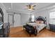 Luxurious main bedroom suite with a trey ceiling, wood floors, sliding barn door, and modern furniture at 30 Devilwood Dr, Four Oaks, NC 27524