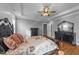 Bright main bedroom with trey ceiling, hardwood floors, recessed lights, large windows, and contemporary decor at 30 Devilwood Dr, Four Oaks, NC 27524