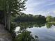 Peaceful view of calm pond with natural foliage on shoreline at 30 Devilwood Dr, Four Oaks, NC 27524