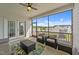 Comfortable screened porch provides outdoor living with armchairs, a coffee table, and views of the surrounding neighborhood at 30 Devilwood Dr, Four Oaks, NC 27524