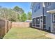 Large backyard with a wood fence, grass, and view of the house with a screened porch at 301 Georgetown Rd, Raleigh, NC 27608