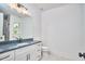 Clean bathroom with white cabinets, a dark countertop, and a large vanity mirror at 301 Georgetown Rd, Raleigh, NC 27608