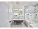 Stylish bathroom with clawfoot tub, designer tile, and glass-enclosed shower at 301 Georgetown Rd, Raleigh, NC 27608