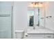 Clean, white bathroom with updated vanity, sink, and glass-enclosed shower at 301 Georgetown Rd, Raleigh, NC 27608