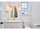 This bright bathroom features a marble vanity, decorative mirror, and a window at 301 Georgetown Rd, Raleigh, NC 27608