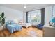 Comfortable bedroom showcasing hardwood floors and a large window at 301 Georgetown Rd, Raleigh, NC 27608