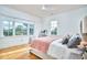 Bedroom featuring hardwood floors, two windows, and soft natural light at 301 Georgetown Rd, Raleigh, NC 27608