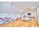 Spacious bonus room with light hardwood floors, large TV, ceiling fan, and plenty of storage at 301 Georgetown Rd, Raleigh, NC 27608