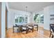 Bright dining room with large windows, wood floors, modern chandelier, and stylish chairs at 301 Georgetown Rd, Raleigh, NC 27608