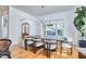 Open concept dining area with wood floors and large windows with views of the front yard at 301 Georgetown Rd, Raleigh, NC 27608