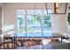 Bright dining room with a large window, a chandelier, and neutral-colored walls at 301 Georgetown Rd, Raleigh, NC 27608