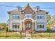 Stately two-story home features brick accents, multiple windows, and manicured landscaping with black metal fencing at 301 Georgetown Rd, Raleigh, NC 27608