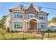 Stylish home with a brick facade and large windows providing plenty of natural light, complemented by a wrought iron fence at 301 Georgetown Rd, Raleigh, NC 27608
