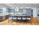 Bright kitchen with stainless appliances, large island with seating, and custom cabinets at 301 Georgetown Rd, Raleigh, NC 27608