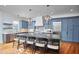 Stunning kitchen with oversized island, marble countertop, pendant lighting, and stainless steel appliances at 301 Georgetown Rd, Raleigh, NC 27608