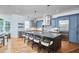 Stunning kitchen with oversized island, marble countertop, pendant lighting, and stainless steel appliances at 301 Georgetown Rd, Raleigh, NC 27608
