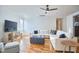 Bright living room featuring hardwood floors, a ceiling fan, and comfortable seating arrangement at 301 Georgetown Rd, Raleigh, NC 27608