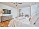 Bright main bedroom with hardwood floors, ceiling fan, and large dresser at 301 Georgetown Rd, Raleigh, NC 27608