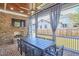 Outdoor brick fireplace and TV on covered screened in porch with wood ceiling at 301 Georgetown Rd, Raleigh, NC 27608