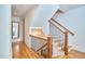 The bright staircase features wooden stairs, iron railings, and hardwood floors at 301 Georgetown Rd, Raleigh, NC 27608