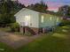 Charming single story home featuring traditional siding, brick foundation and an inviting back entrance under a colorful sunset at 3016 Fields Dr, Raleigh, NC 27603