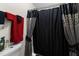 Close-up of a bathroom featuring towels, a toilet, and a shower with a decorated shower curtain at 3016 Fields Dr, Raleigh, NC 27603