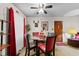 Bright dining area with a glass-top table, red accents, and a ceiling fan at 3016 Fields Dr, Raleigh, NC 27603