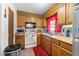 Functional kitchen with oak cabinetry, a window over the sink and essential appliances at 3016 Fields Dr, Raleigh, NC 27603