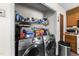 Laundry room with a washer and dryer and shelves with cleaning supplies at 3016 Fields Dr, Raleigh, NC 27603