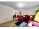 Inviting open floor plan featuring a cozy red sofa, plush textures and nearby dining area at 3016 Fields Dr, Raleigh, NC 27603