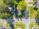 Aerial view of a home with a traditional green roof, surrounded by lush trees and a well-maintained yard at 302 N Sumner St, Selma, NC 27576