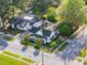 Aerial view of a charming home with a fenced yard, surrounded by mature trees and well-kept landscaping at 302 N Sumner St, Selma, NC 27576