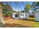 Spacious backyard featuring a wooden deck, mature trees, and room for outdoor activities at 302 N Sumner St, Selma, NC 27576
